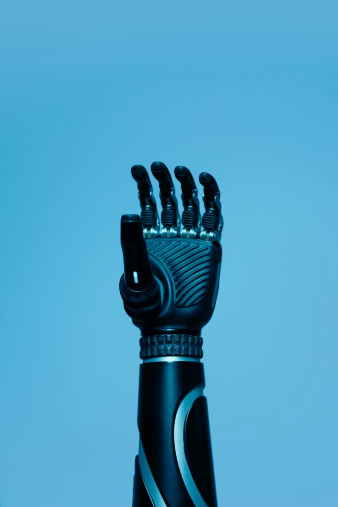 A high-tech robotic prosthetic arm reaching upwards on a blue background, symbolizing innovation in biotechnology.